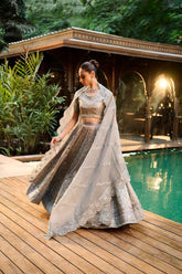 Stunning grey lehnga choli with intricate silver embroidery and bridal details.