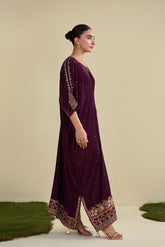 FW25DA-2806 Jewel-toned magenta velvet kaftan with gold craftsmanship on cuffs and neckline.