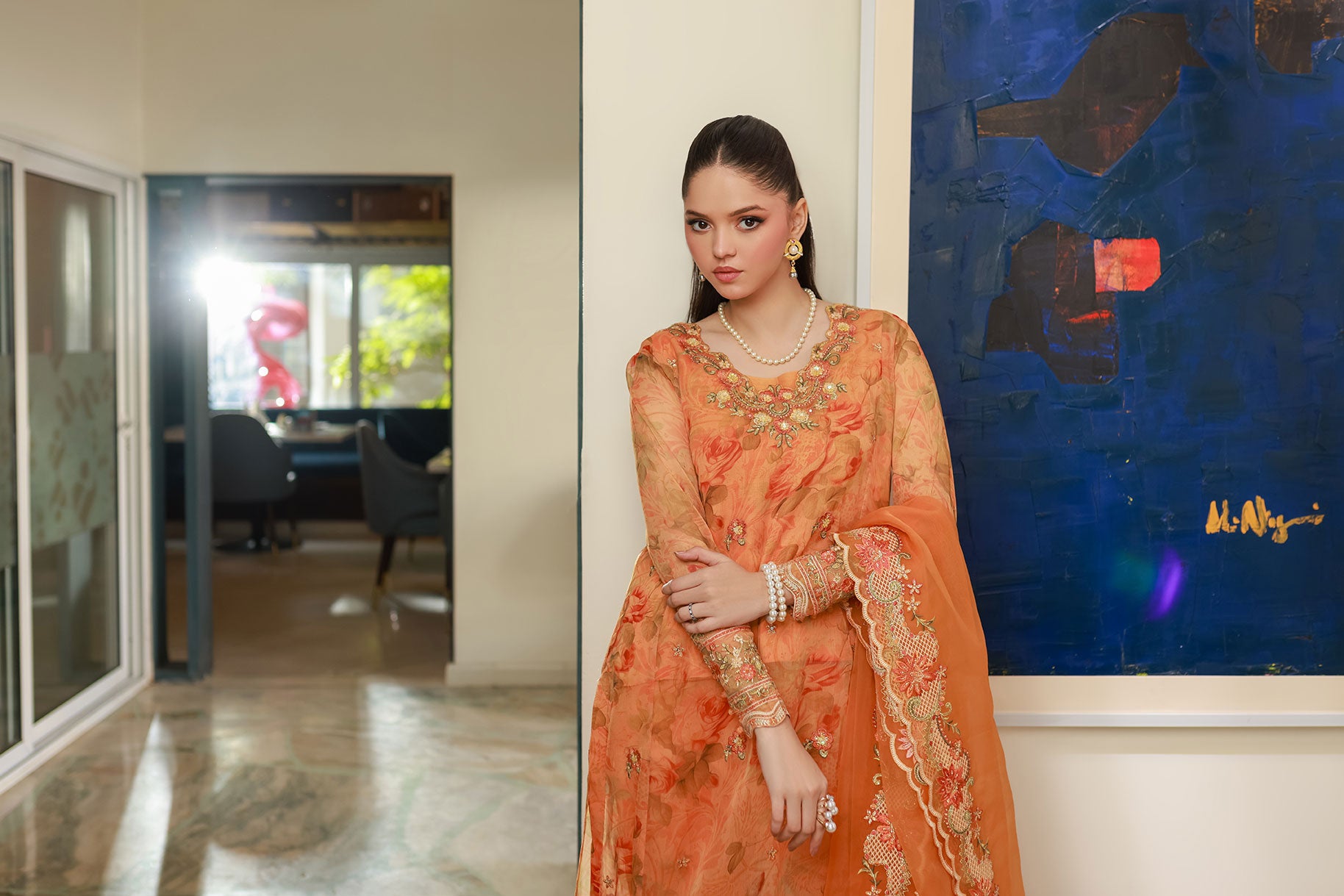 SS25DA-2716 Orange 2-piece printed chiffon kurta with floral embroidery and lace detailing on daman and sleeves.