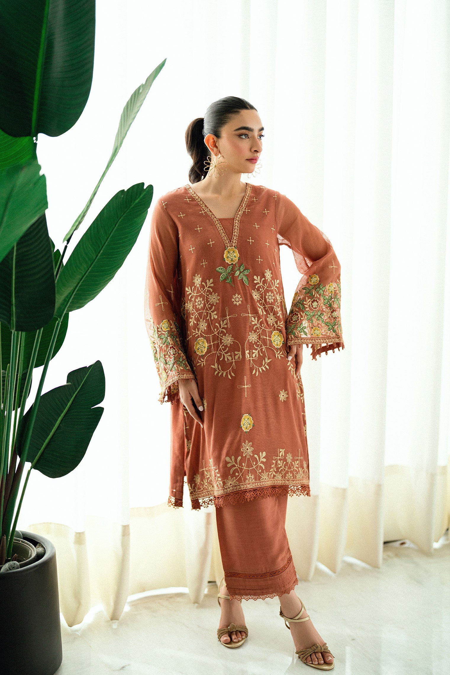 Rust 2-piece silk ensemble with intricate thread embroidery.