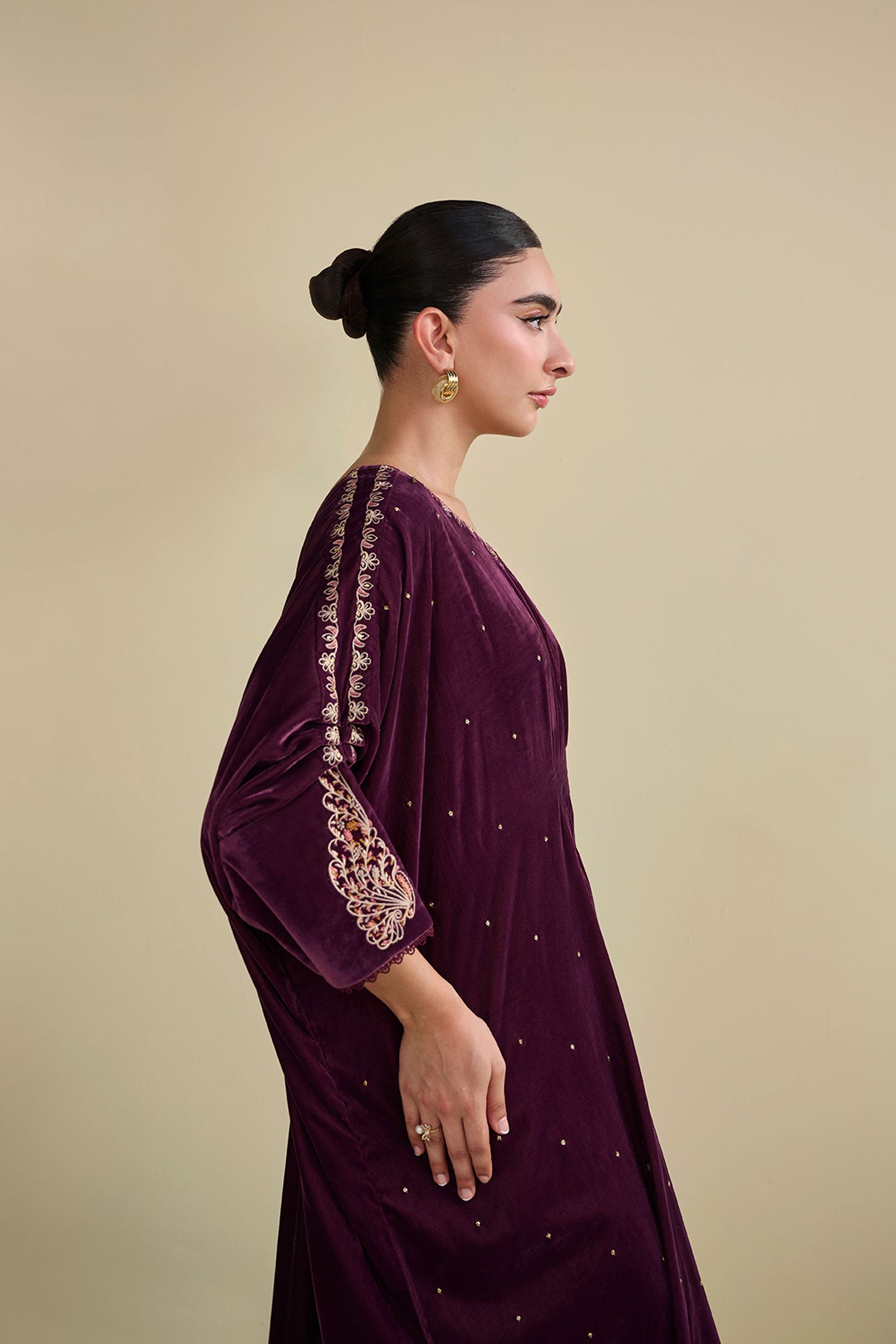 FW25DA-2806 Jewel-toned magenta velvet kaftan with gold craftsmanship on cuffs and neckline.