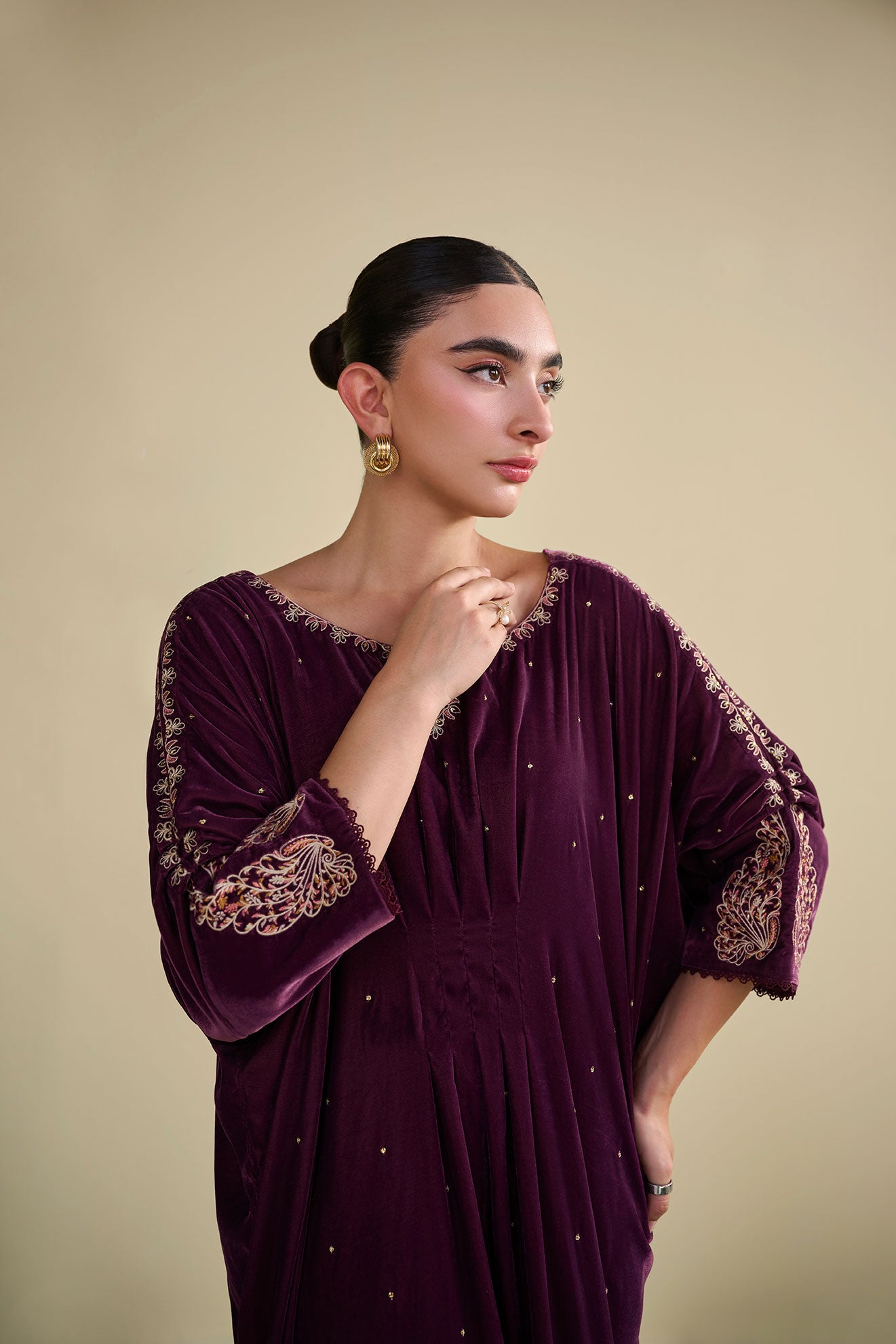 FW25DA-2806 Jewel-toned magenta velvet kaftan with gold craftsmanship on cuffs and neckline.