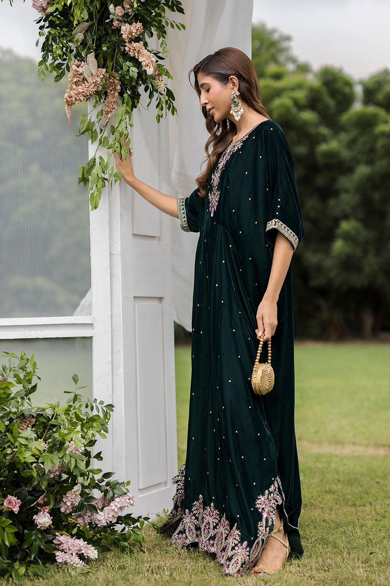 FW25DA-2829 Bottle Green Kaftan: Emerald velvet kaftan with gold and pink embroidery along the neckline and hem for a regal silhouette.