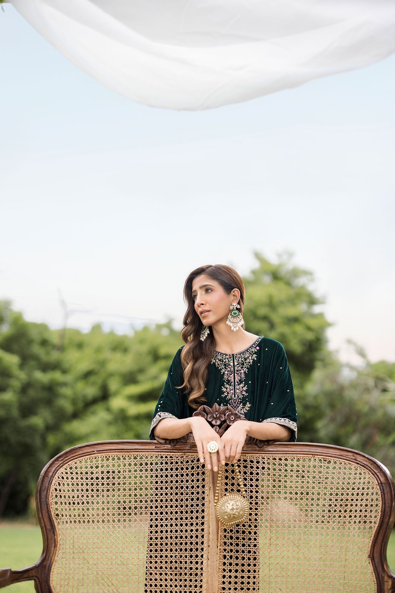 FW25DA-2829 Bottle Green Kaftan: Emerald velvet kaftan with gold and pink embroidery along the neckline and hem for a regal silhouette.