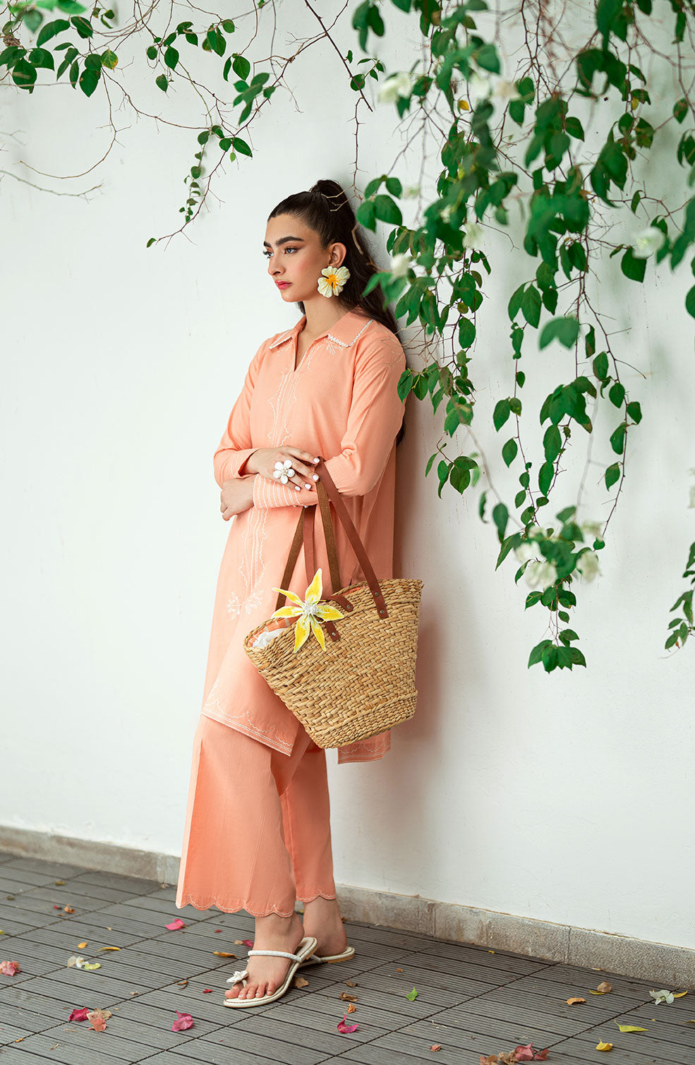 SS25DC-2573 Peach 2-piece ensemble featuring an embroidered kurta with delicate floral threadwork on the neckline and sleeves, paired with solid trousers.