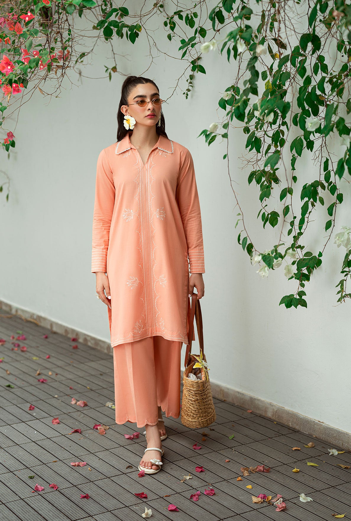 SS25DC-2573 Peach 2-piece ensemble featuring an embroidered kurta with delicate floral threadwork on the neckline and sleeves, paired with solid trousers.