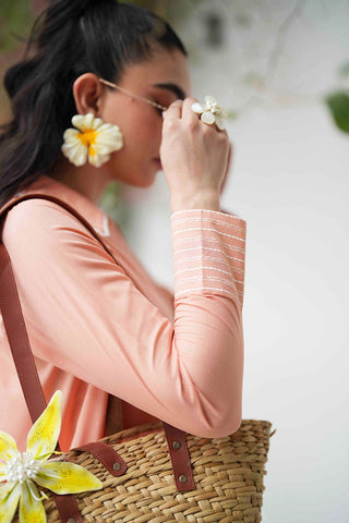 SS25DC-2573 Peach 2-piece ensemble featuring an embroidered kurta with delicate floral threadwork on the neckline and sleeves, paired with solid trousers.