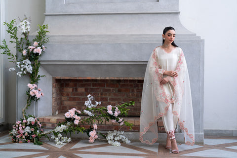 Off-white 3-piece cotton net ensemble with contrasting pink and green floral embroidery.