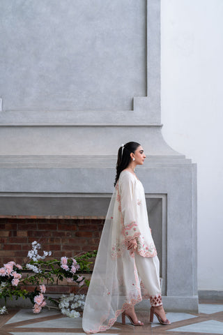 Off-white 3-piece cotton net ensemble with contrasting pink and green floral embroidery.