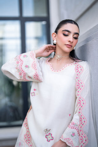 Off-white 3-piece cotton net ensemble with contrasting pink and green floral embroidery.