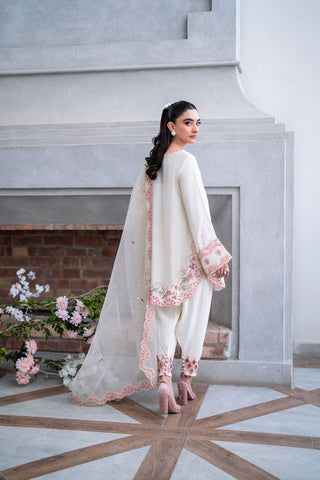 Off-white 3-piece cotton net ensemble with contrasting pink and green floral embroidery.