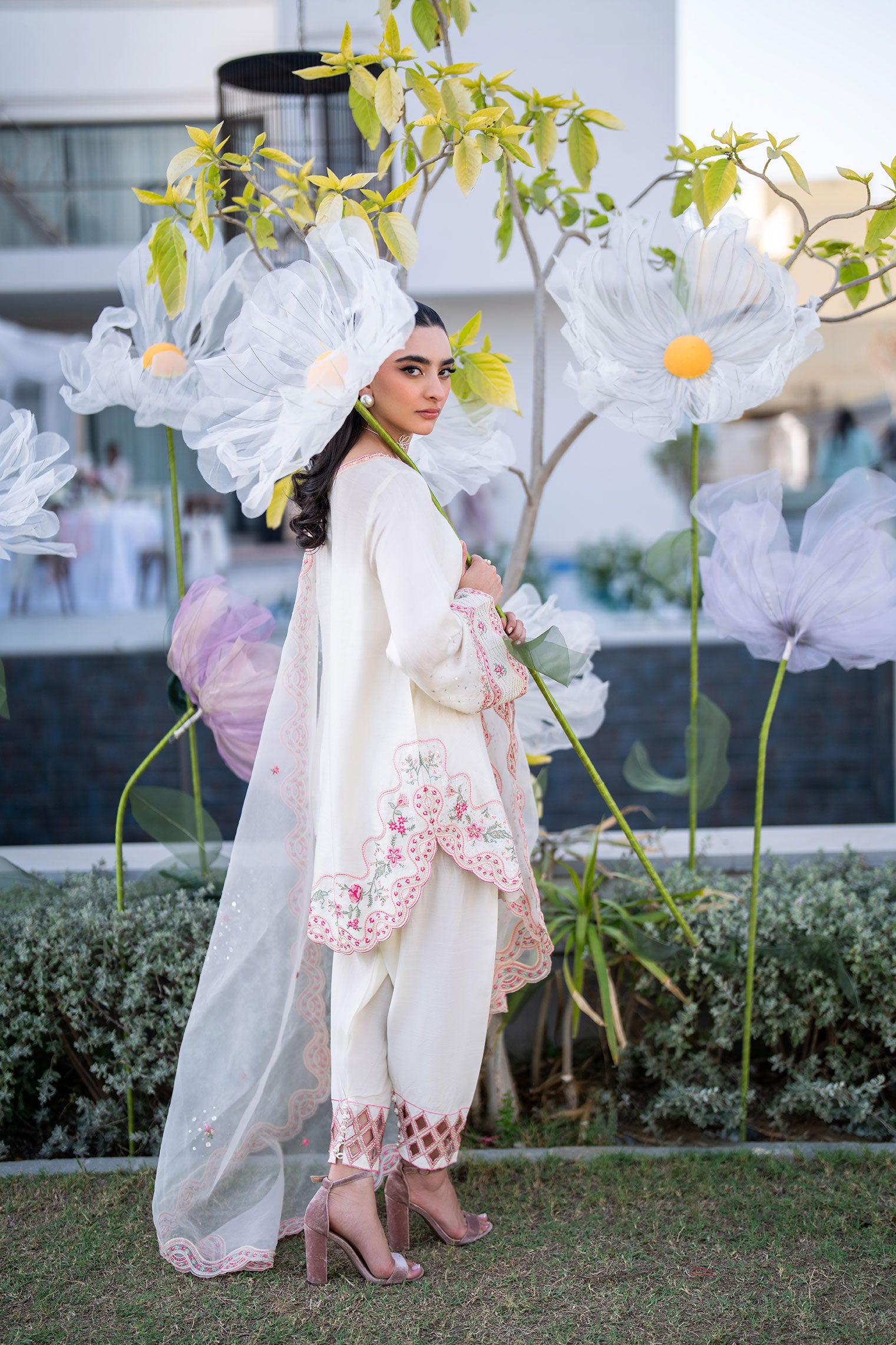 Off-white 3-piece cotton net ensemble with contrasting pink and green floral embroidery.