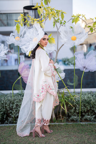 Off-white 3-piece cotton net ensemble with contrasting pink and green floral embroidery.