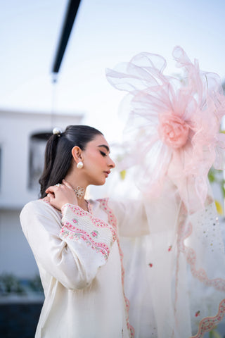 Off-white 3-piece cotton net ensemble with contrasting pink and green floral embroidery.