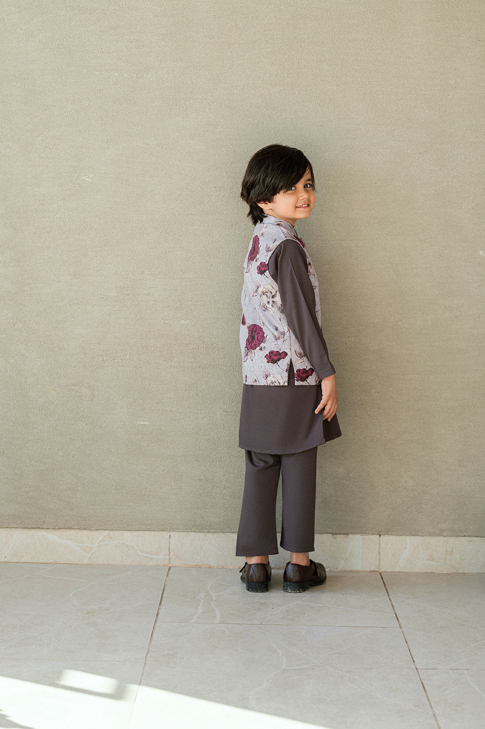 Boys dark grey kurta pajama with floral waistcoat.