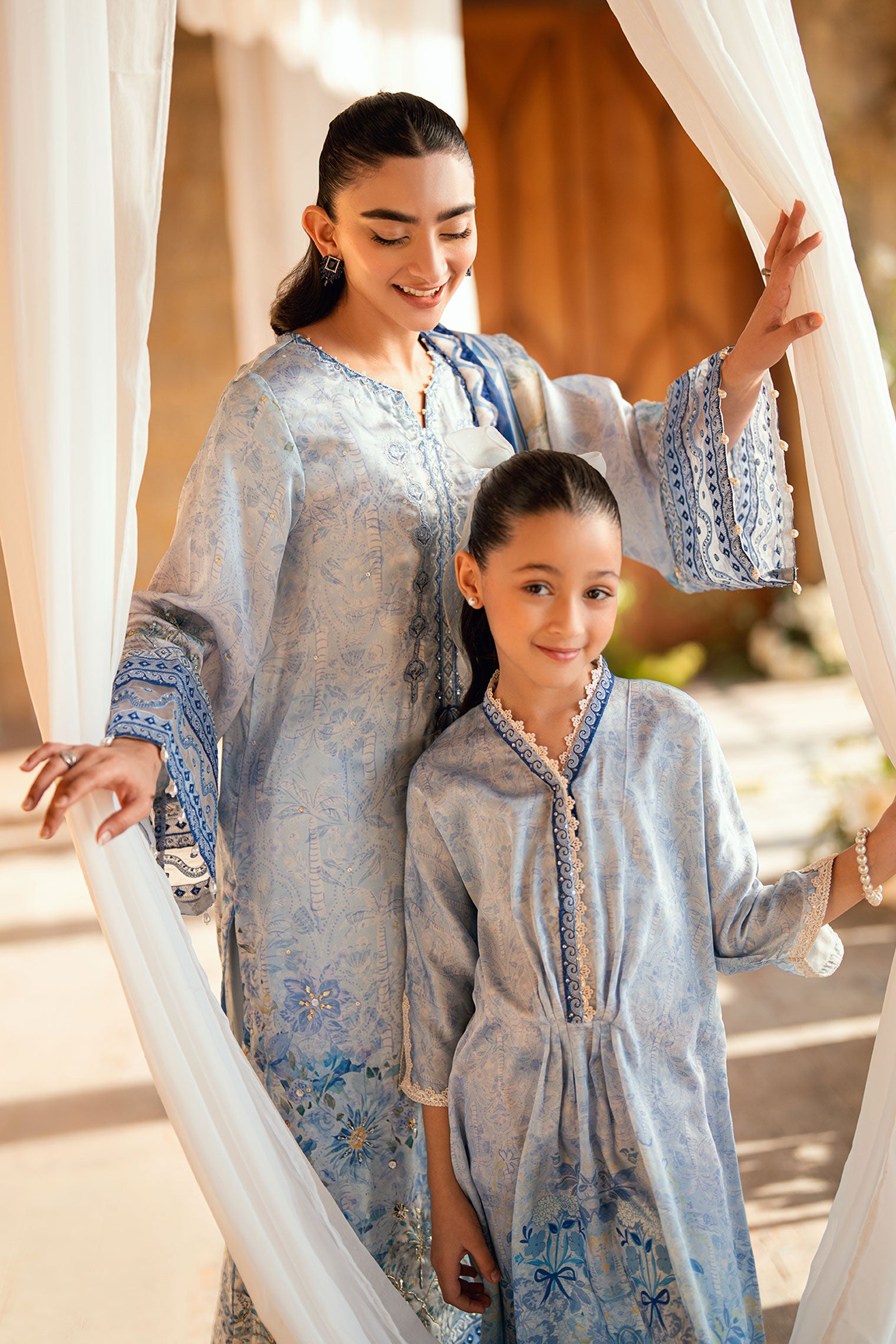 Kids sky blue shamoz silk kaftan with light embellishments.