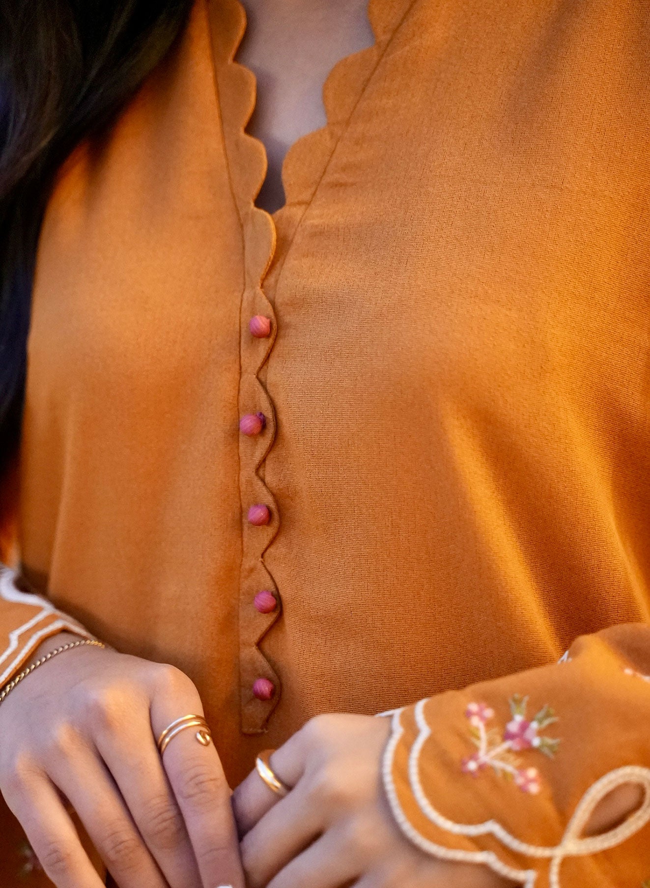 FW25DC-2881 Mustard 2-piece karandi ensemble with white and orange embroidery and scalloped neckline.