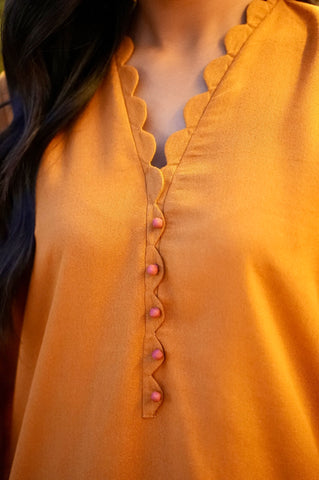 FW25DC-2881 Mustard 2-piece karandi ensemble with white and orange embroidery and scalloped neckline.