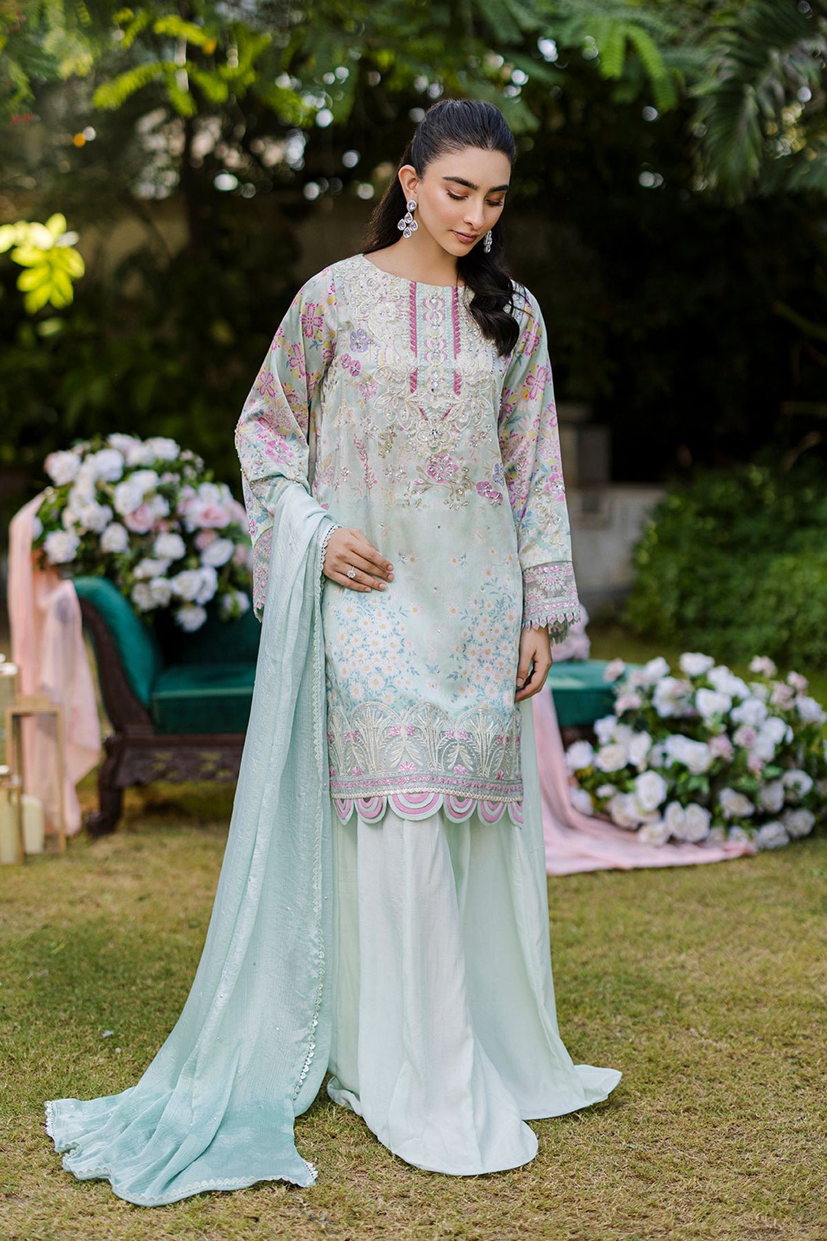 Mint green silk tunic featuring lilac and blush thread embroidery with subtle sequin accents.