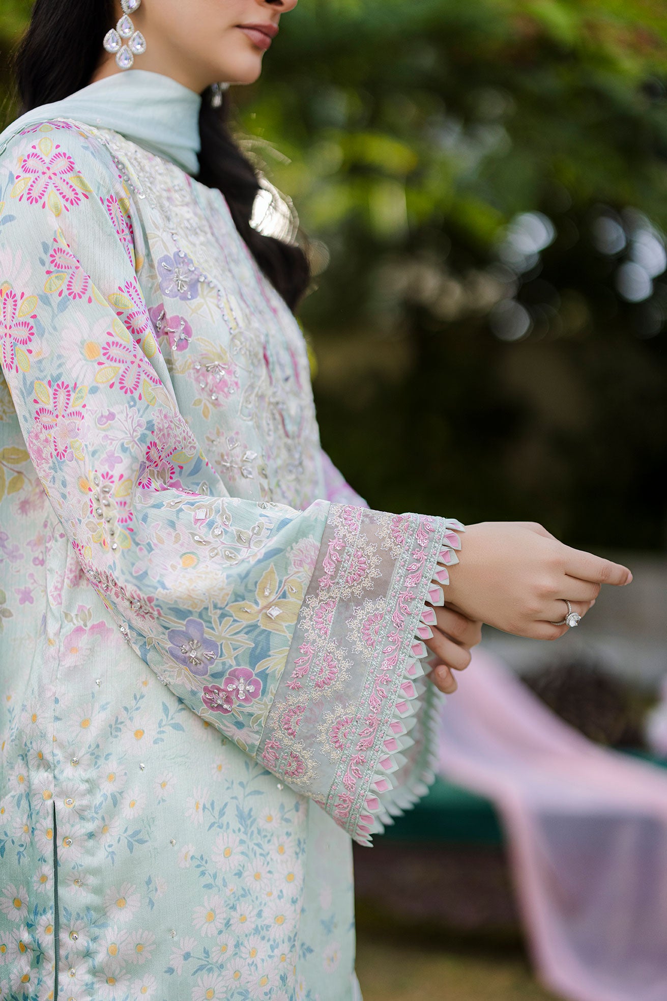 Mint green silk tunic featuring lilac and blush thread embroidery with subtle sequin accents.