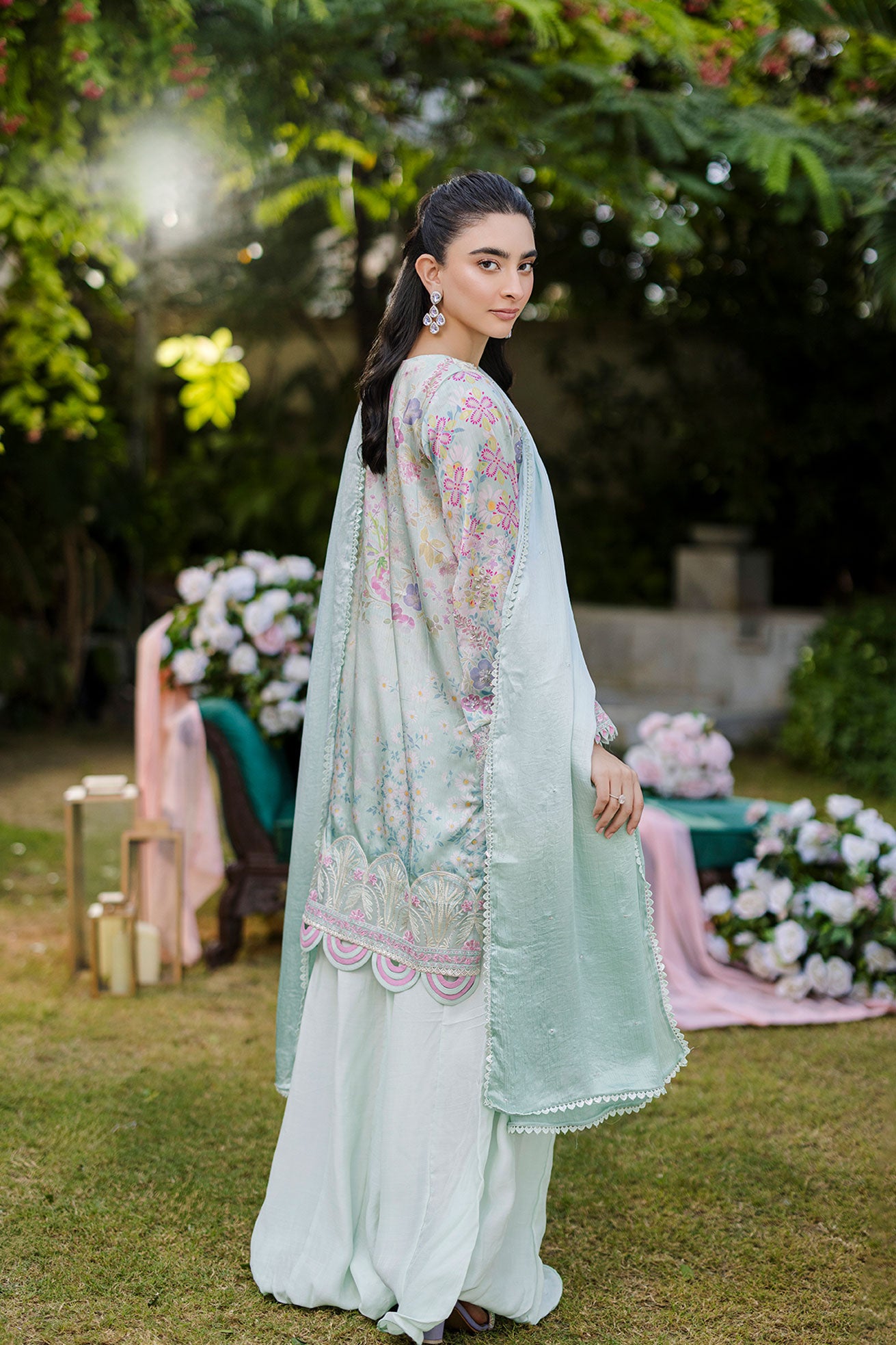 Mint green silk tunic featuring lilac and blush thread embroidery with subtle sequin accents.