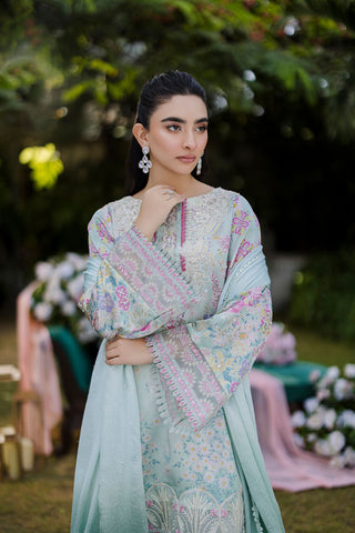 Mint green silk tunic featuring lilac and blush thread embroidery with subtle sequin accents.