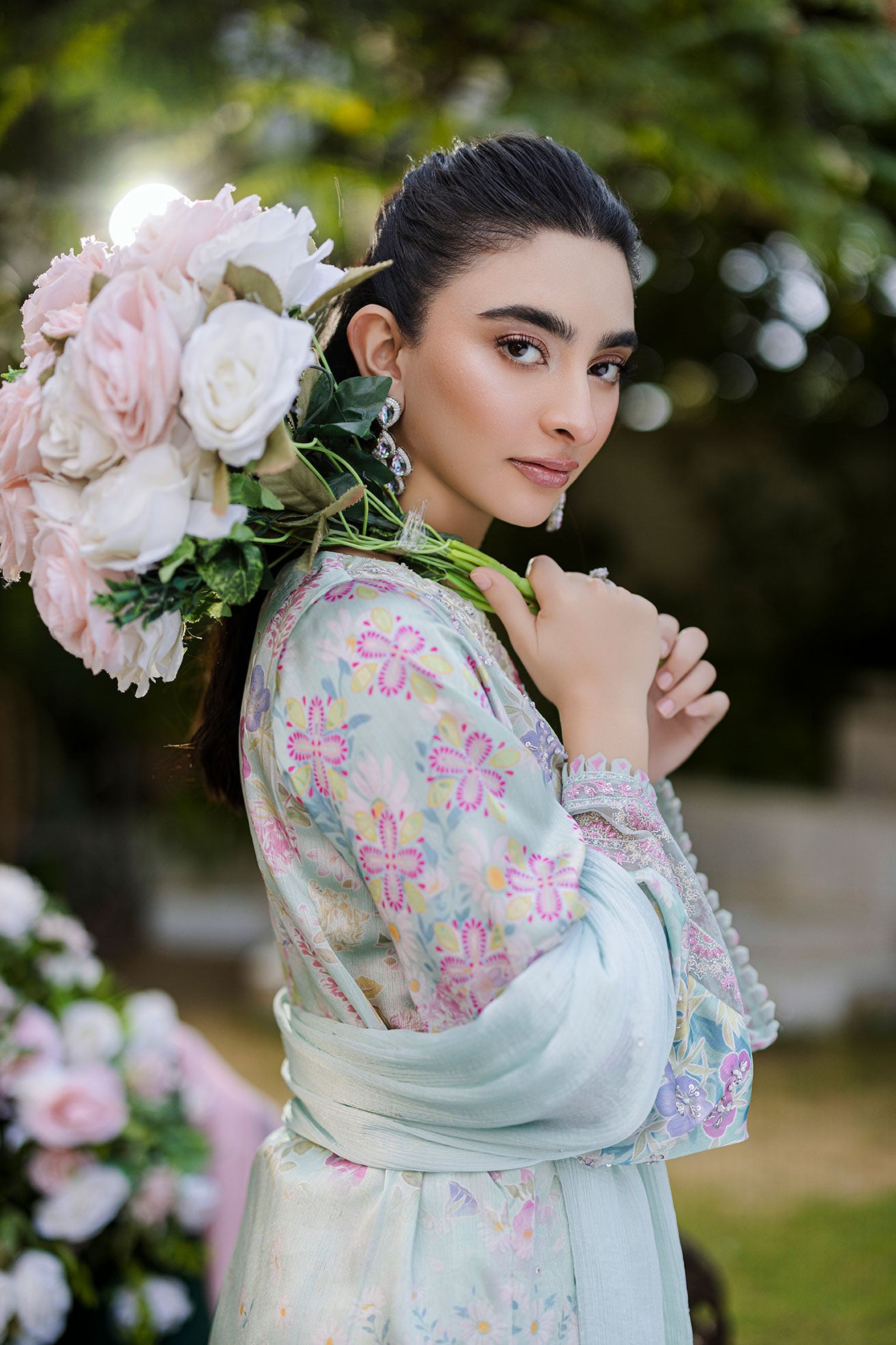 Mint green silk tunic featuring lilac and blush thread embroidery with subtle sequin accents.