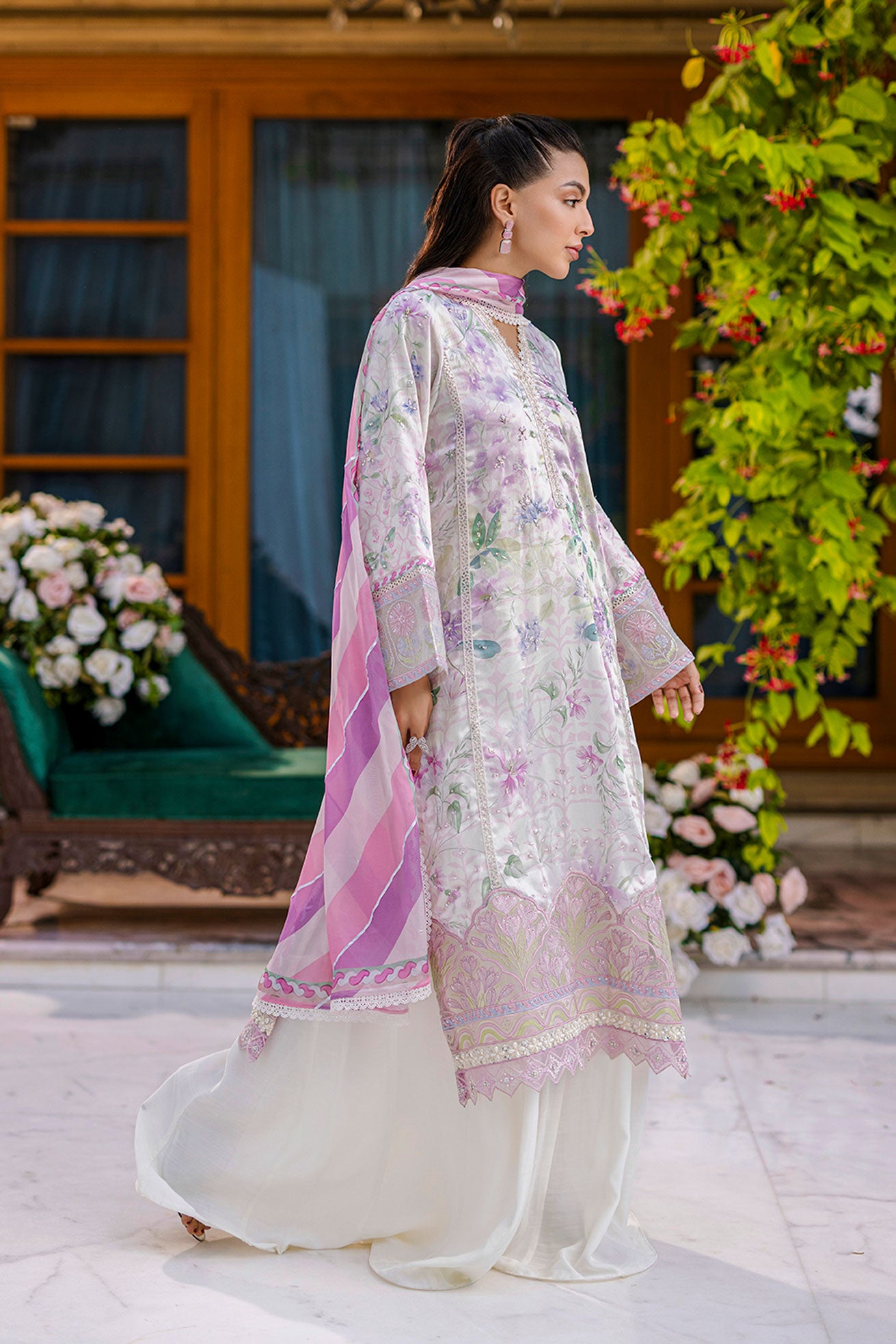 Off-white silk tunic blooming in lilac and blush tones with plain flared trousers and scalloped borders.