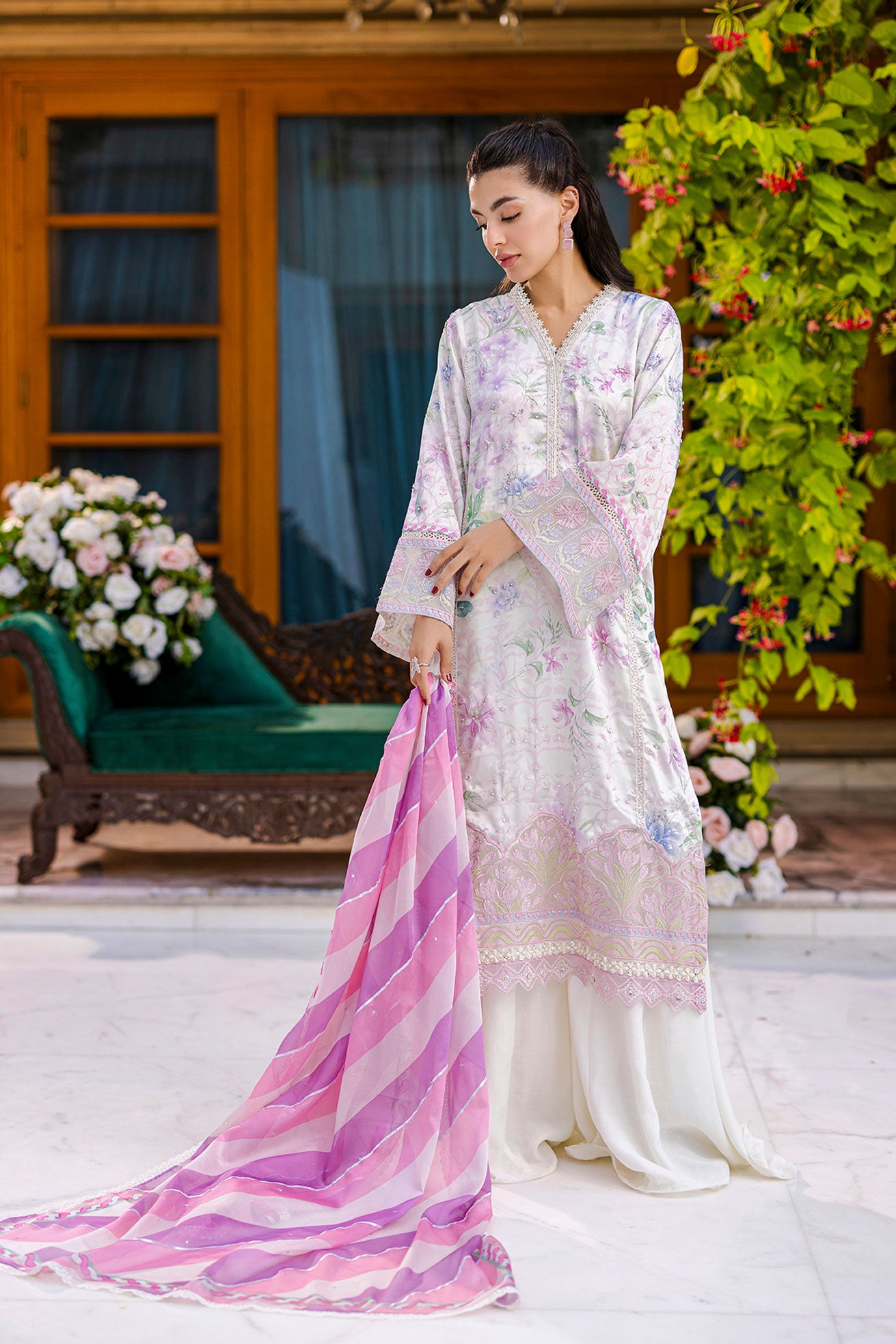 Off-white silk tunic blooming in lilac and blush tones with plain flared trousers and scalloped borders.