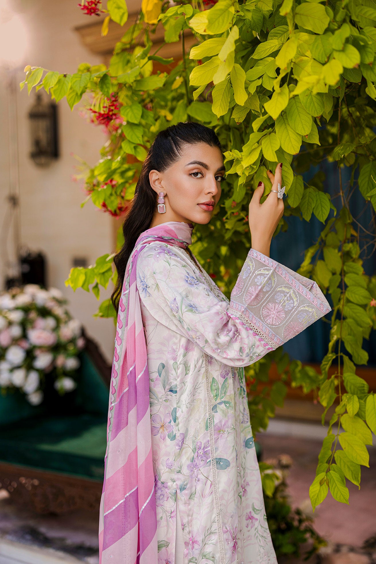 Off-white silk tunic blooming in lilac and blush tones with plain flared trousers and scalloped borders.