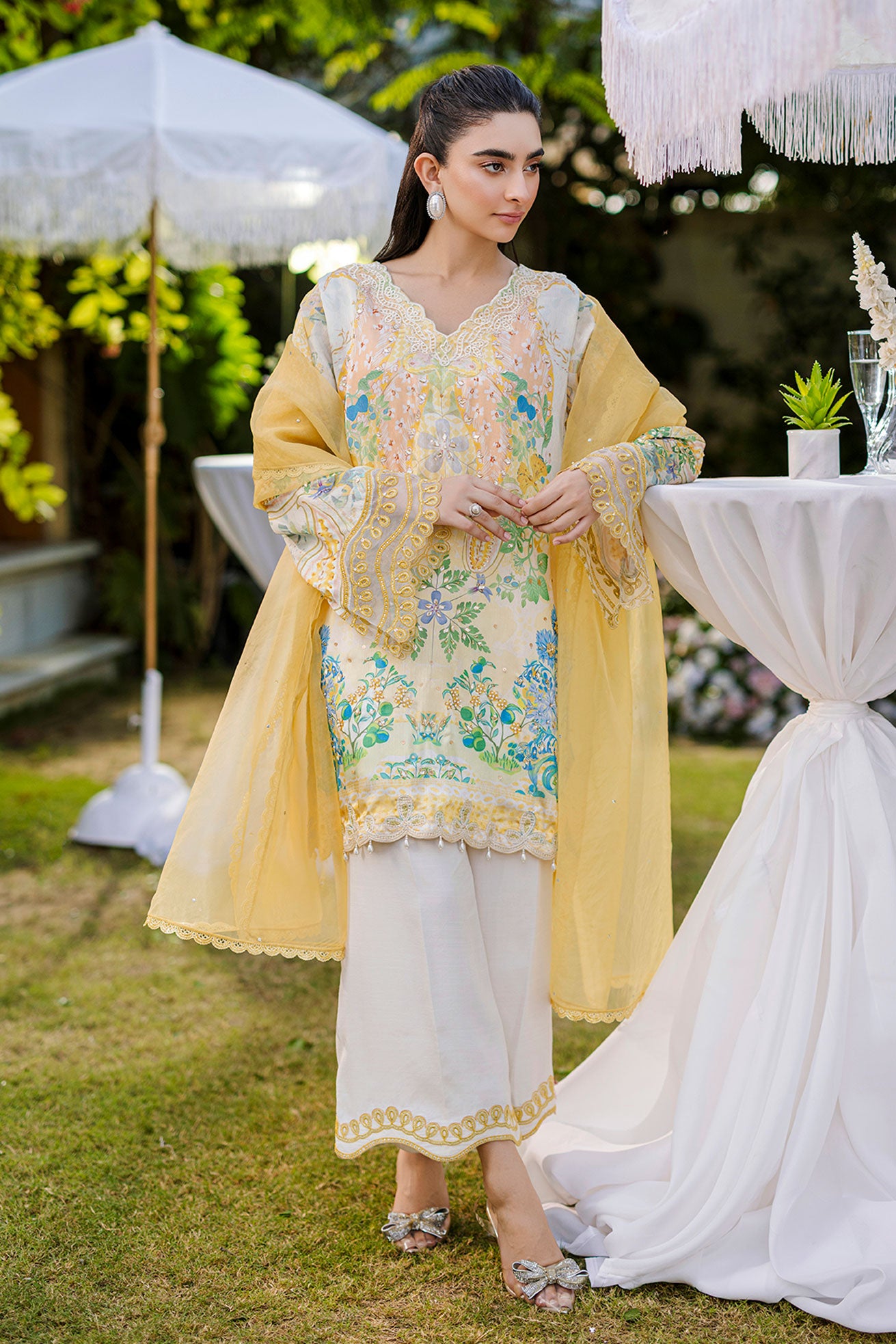 Soft yellow silk ensemble featuring floral and paisley motifs in blue, green, and peach tones.