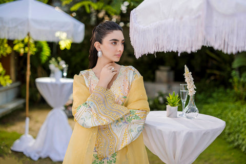 Soft yellow silk ensemble featuring floral and paisley motifs in blue, green, and peach tones.