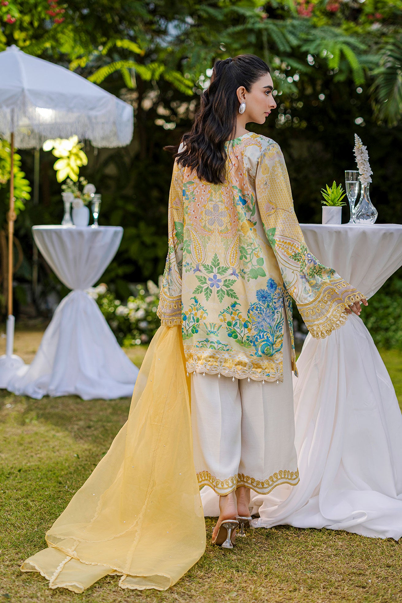 Soft yellow silk ensemble featuring floral and paisley motifs in blue, green, and peach tones.