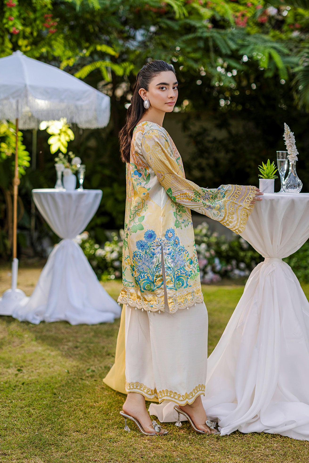Soft yellow silk ensemble featuring floral and paisley motifs in blue, green, and peach tones.
