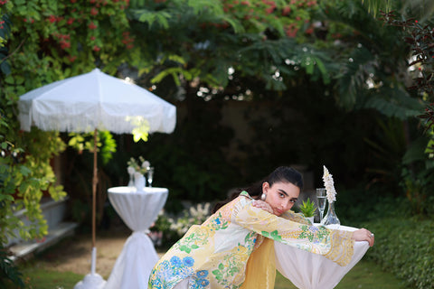 Soft yellow silk ensemble featuring floral and paisley motifs in blue, green, and peach tones.