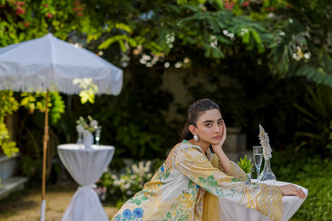 Soft yellow silk ensemble featuring floral and paisley motifs in blue, green, and peach tones.