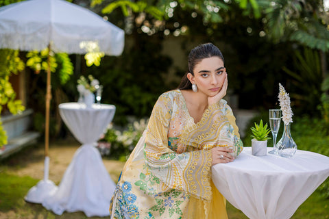 Soft yellow silk ensemble featuring floral and paisley motifs in blue, green, and peach tones.