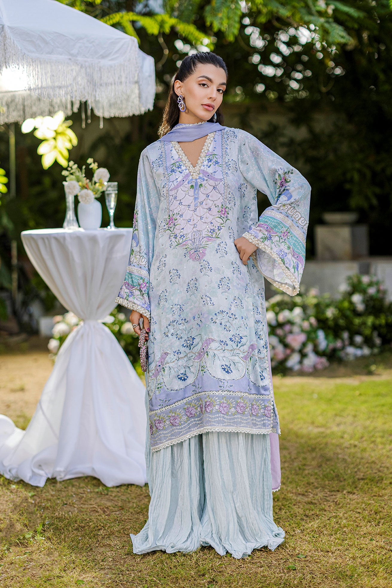 Sky blue 2-piece silk suit with sophisticated hand detailing.