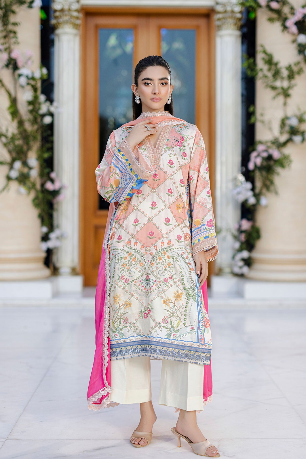 Ethereal orange silk creation with dainty floral embroidery across a checkered motif layout.