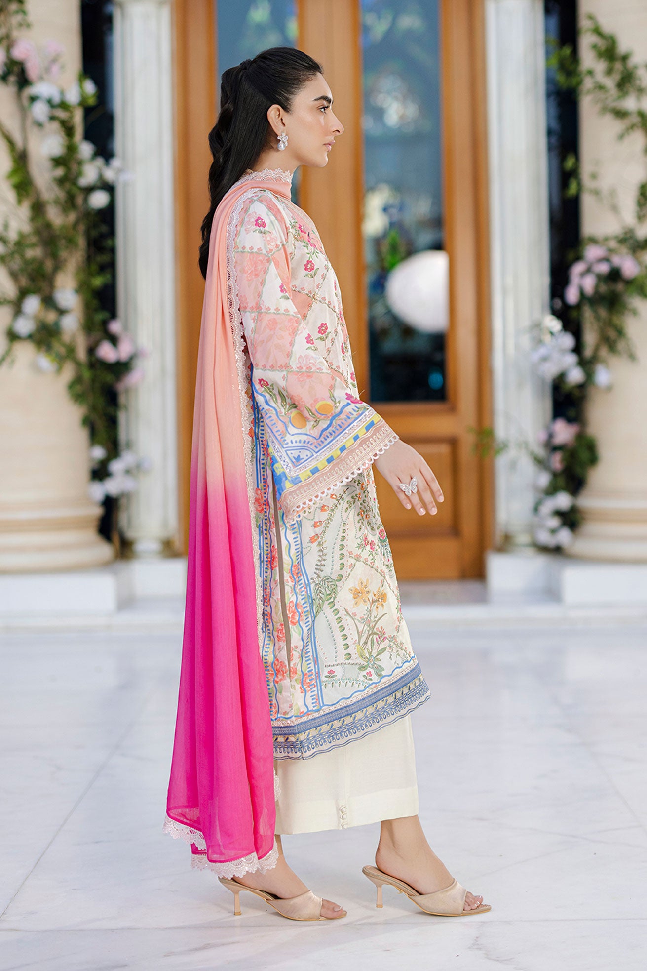 Ethereal orange silk creation with dainty floral embroidery across a checkered motif layout.