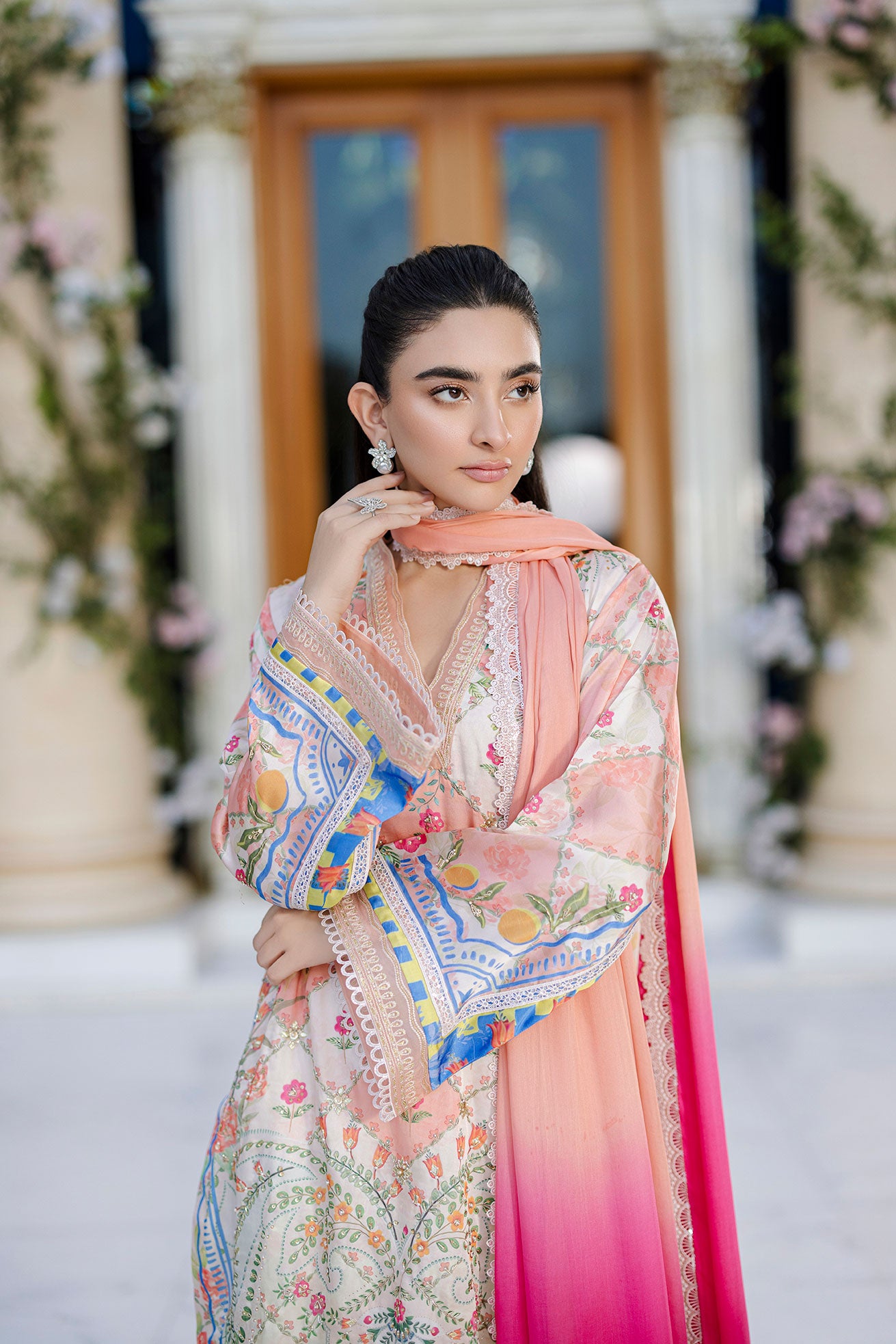 Ethereal orange silk creation with dainty floral embroidery across a checkered motif layout.