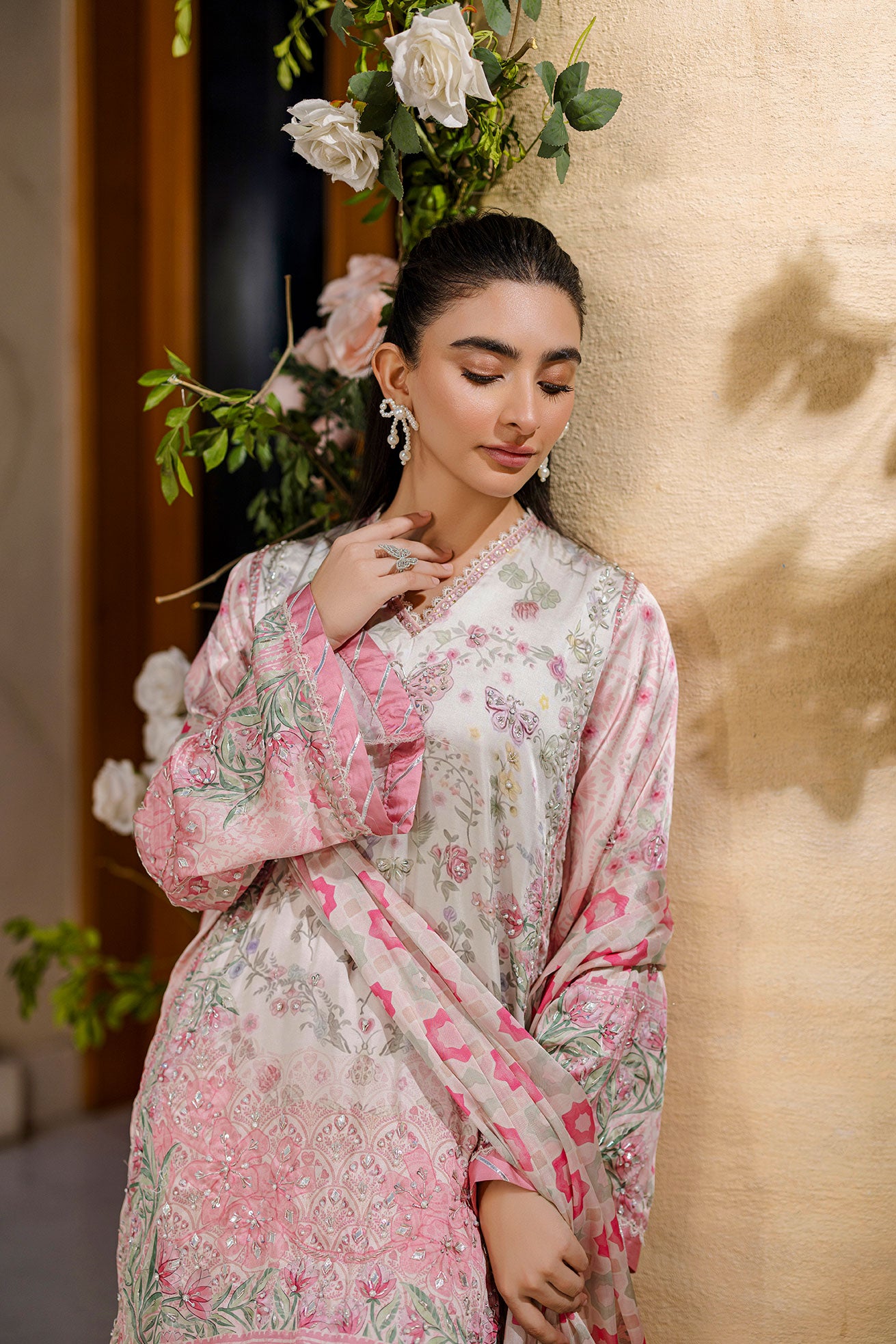 Feminine pink 2-piece silk tunic featuring blooming floral accents and matching flared solid trousers.