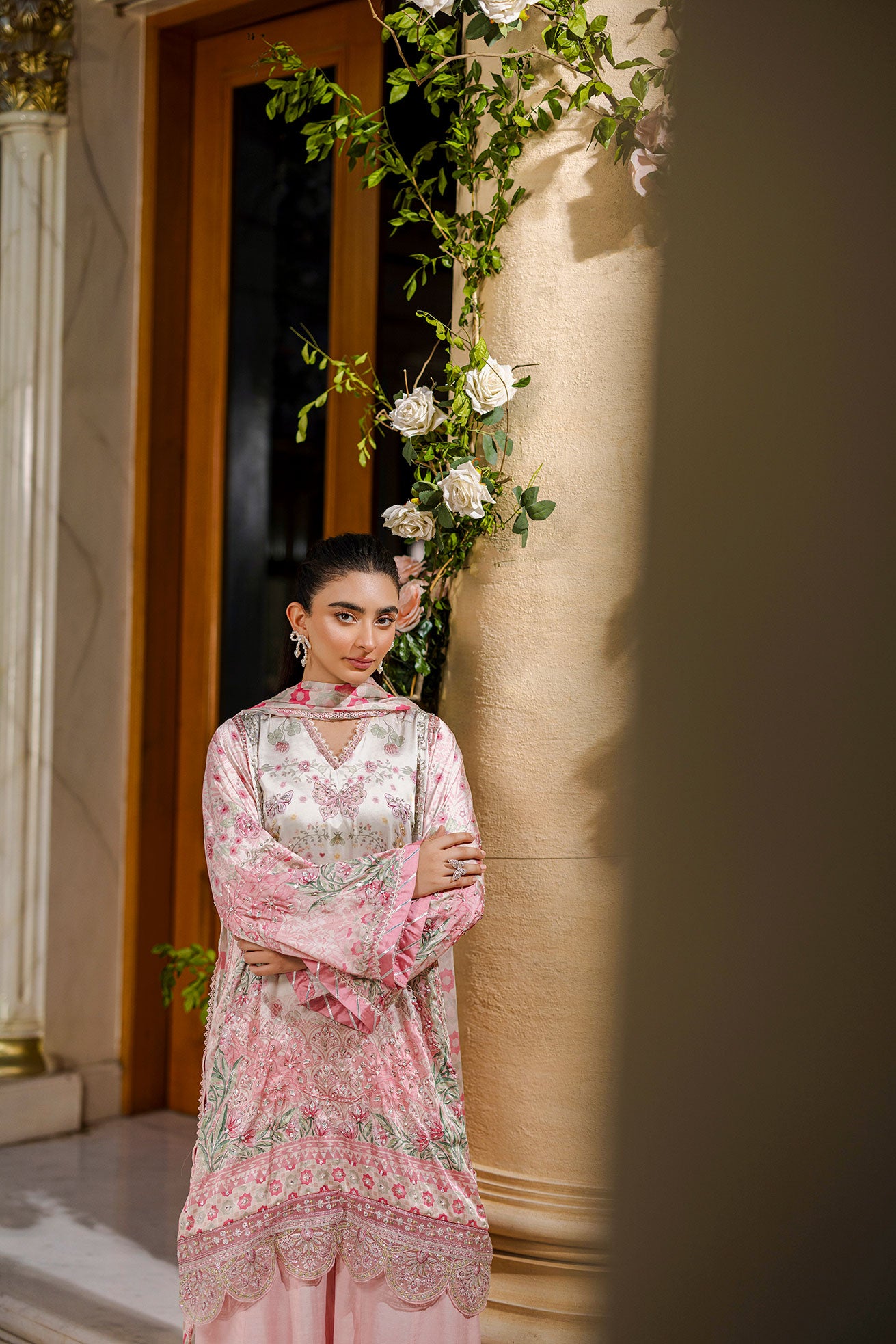 Feminine pink 2-piece silk tunic featuring blooming floral accents and matching flared solid trousers.