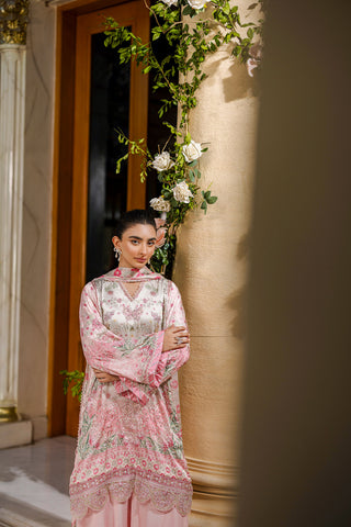 Feminine pink 2-piece silk tunic featuring blooming floral accents and matching flared solid trousers.