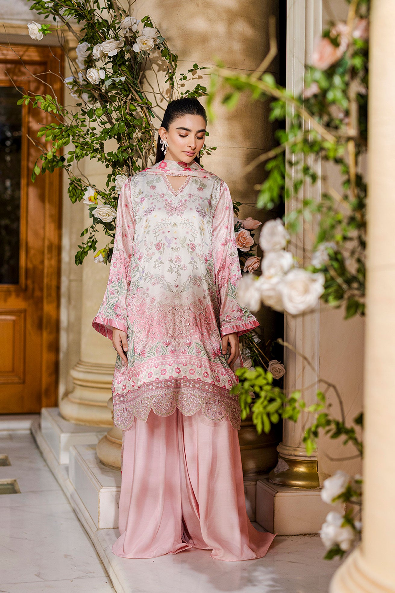 Feminine pink 2-piece silk tunic featuring blooming floral accents and matching flared solid trousers.